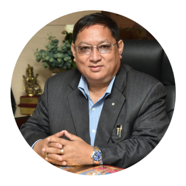 Portrait of Mr Umesh Shrestha wearing formal suit with blue background
